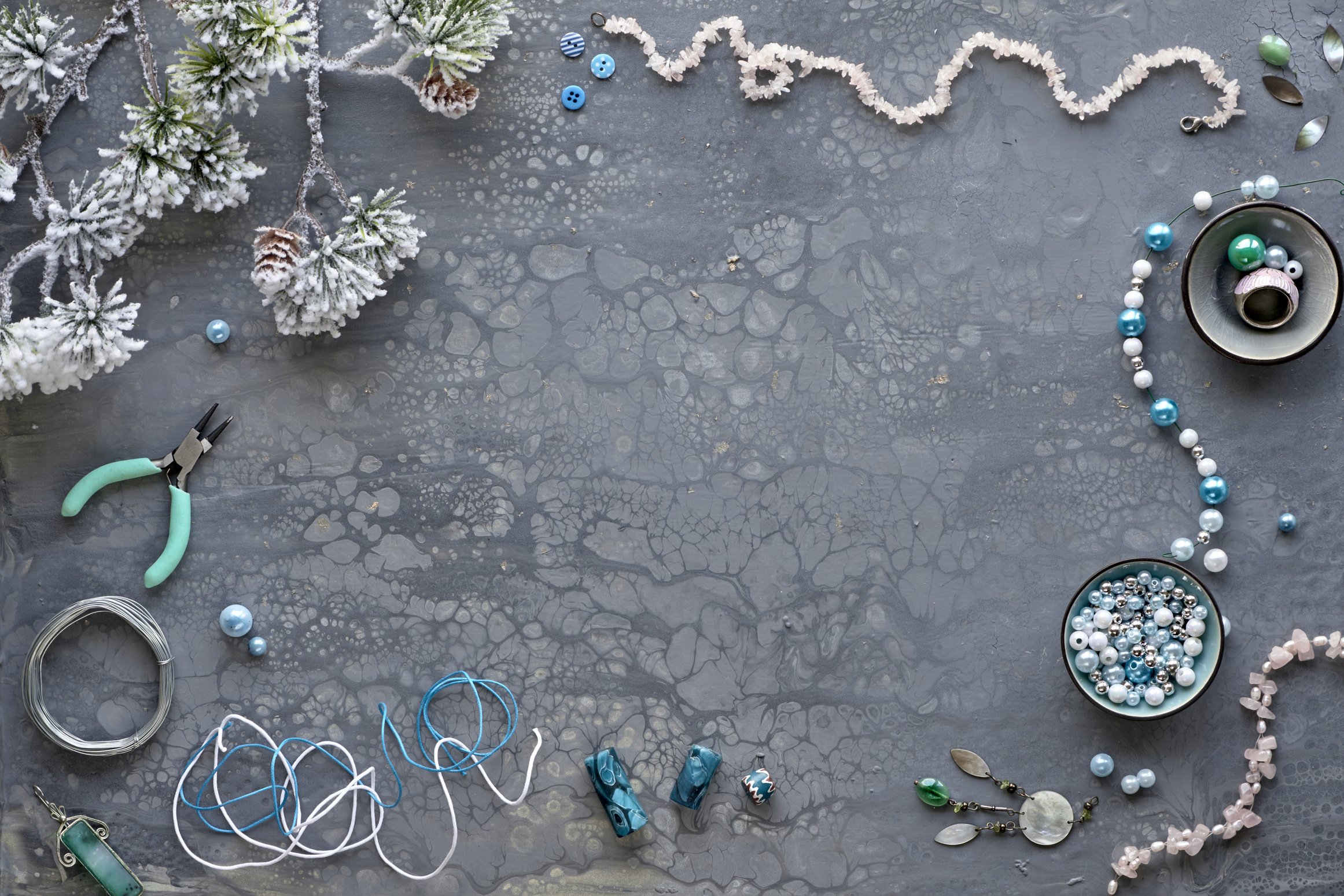 Winter Jewelry Making Composition on Gray Textured Background